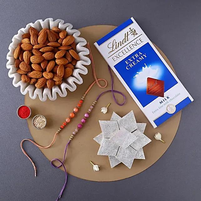 Peachy Rakhi Set With Sweet Treats