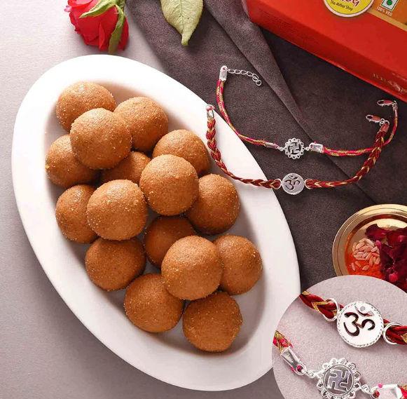 Enchanting Pair of Silver Rakhis With Scrumptious Besan Ladoo