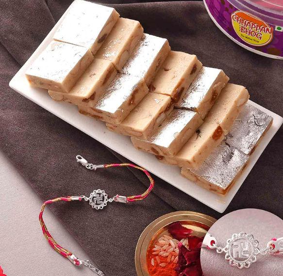 Blessed Swastika Silver Bracelet Rakhi With Flavorful Kaju Anjeer Barfis